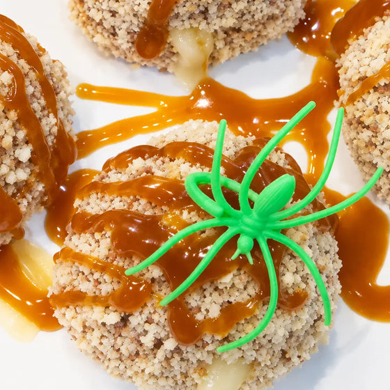 Thumbnail for article: Spider Web Turkey Meatballs presented with glaze and a neon green spider ring