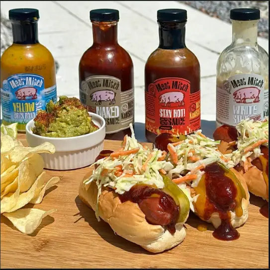WHUCAMOLE Dogs shown with the Meat Mitch sauce lineup