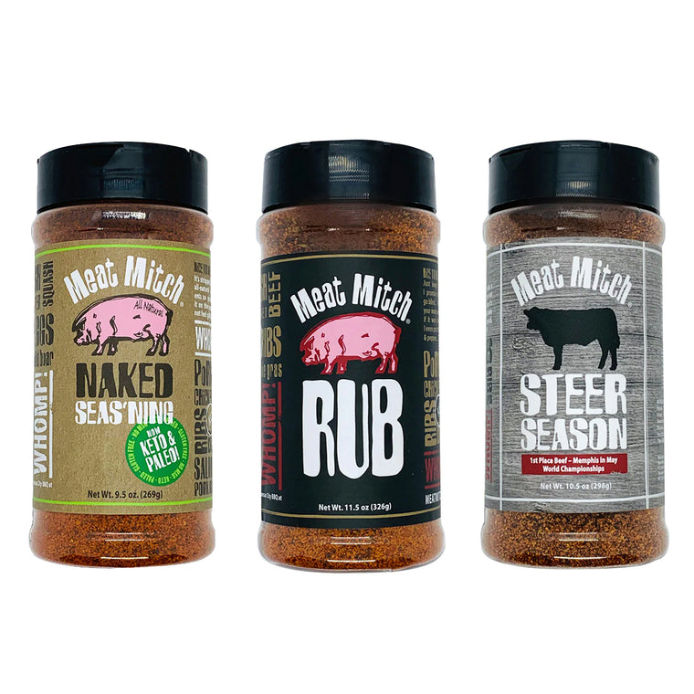 Three bottles of Meat Mitch brand barbecue rub, labeled 'Naked Seasing', 'Competition WHOMP! Rub', and 'Steer Season'.